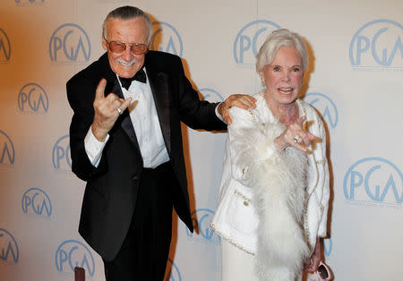 FILE PHOTO - Stan Lee, former president and chairman of Marvel Comics, and wife Joan gesture as they arrive at the 23rd annual Producers Guild Awards in Beverly Hills, California, January 21, 2012. Lee received the Guild's Vanguard Award at the event. REUTERS/Fred Prouser/File Photo