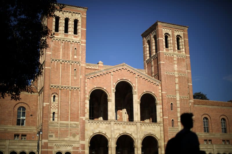 A student walks past Royce Hall on the University of California Los Angeles (UCLA) campus in Los Angeles