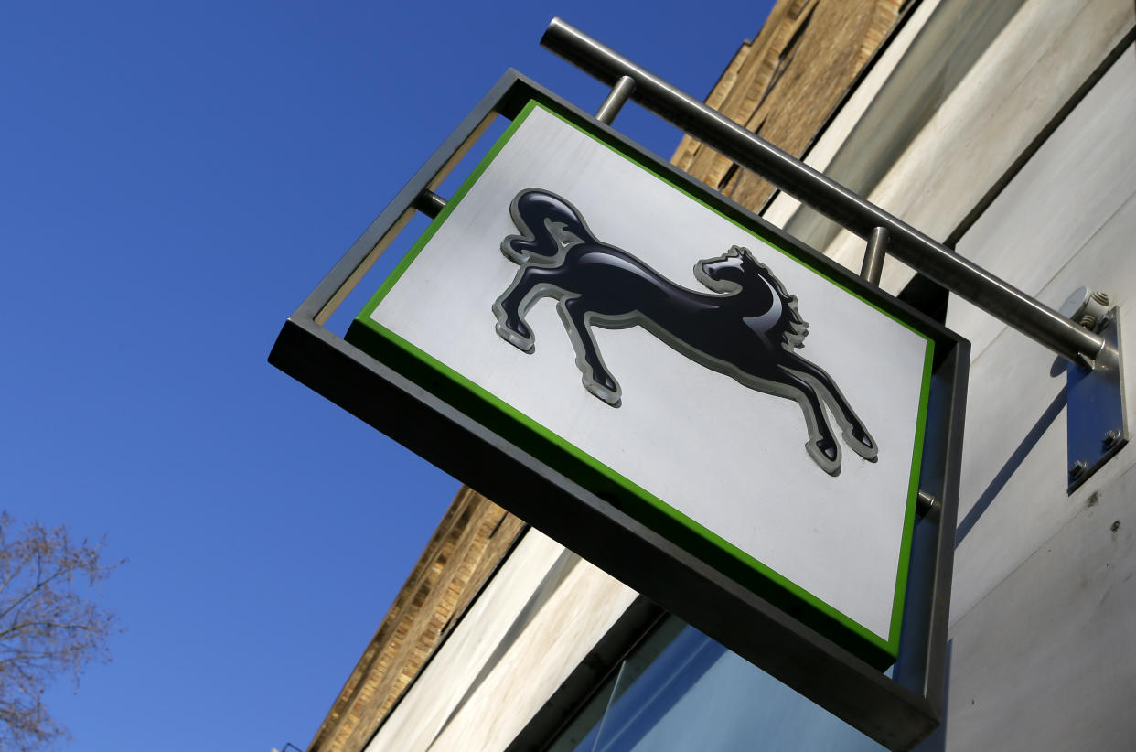 The logo hangs outside a branch of Lloyds Bank in London, Thursday, Jan. 28, 2016. Britain's Chancellor George Osborne has announced that the sale of the government's stake in Lloyds Banking Group will be delayed. (AP Photo/Kirsty Wigglesworth)