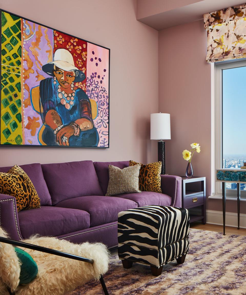 Purple sofa, zebra print footstool, pink walls