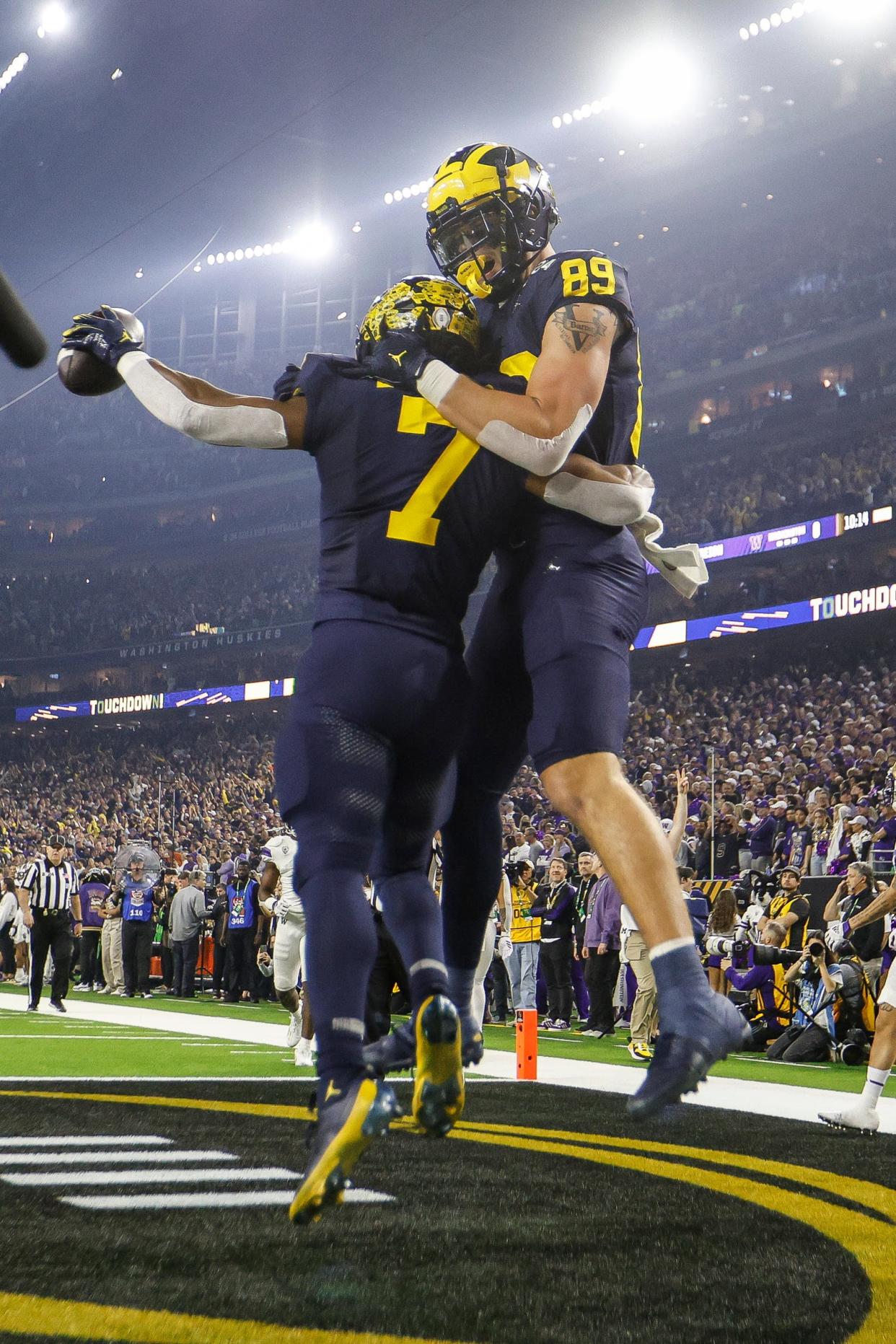 Michigan running back Donovan Edwards celebrates a touchdown against Washington with tight end AJ Barner (89) during the first half of the national championship game at NRG Stadium in Houston, Texas on Monday, Jan. 8, 2024.