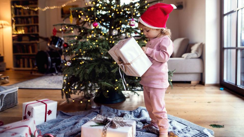 Child opens Christmas presents