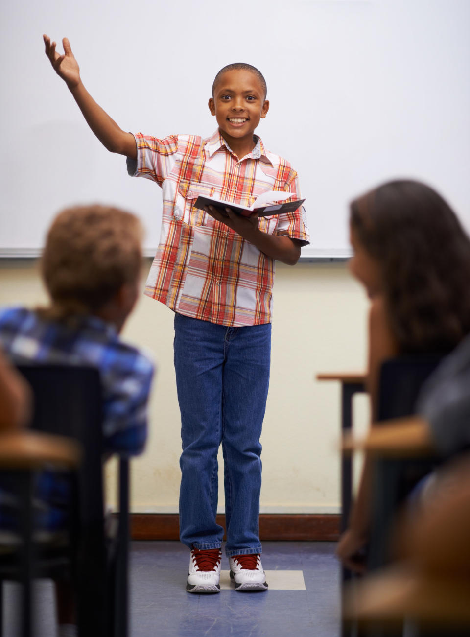 A young boy at the front of the class