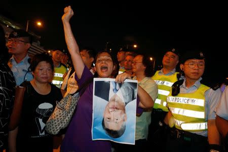 A protester shouts with a photo of Chinese President Xi Jinping, three days before the 20th anniversary of the territory's handover to Chinese rule, in Hong Kong, China June 28, 2017. REUTERS/Bobby Yip