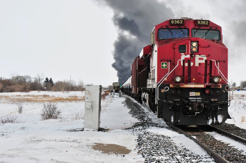 Smoke rises from a fire at the site of a CP Rail train car derailment near Guernsey