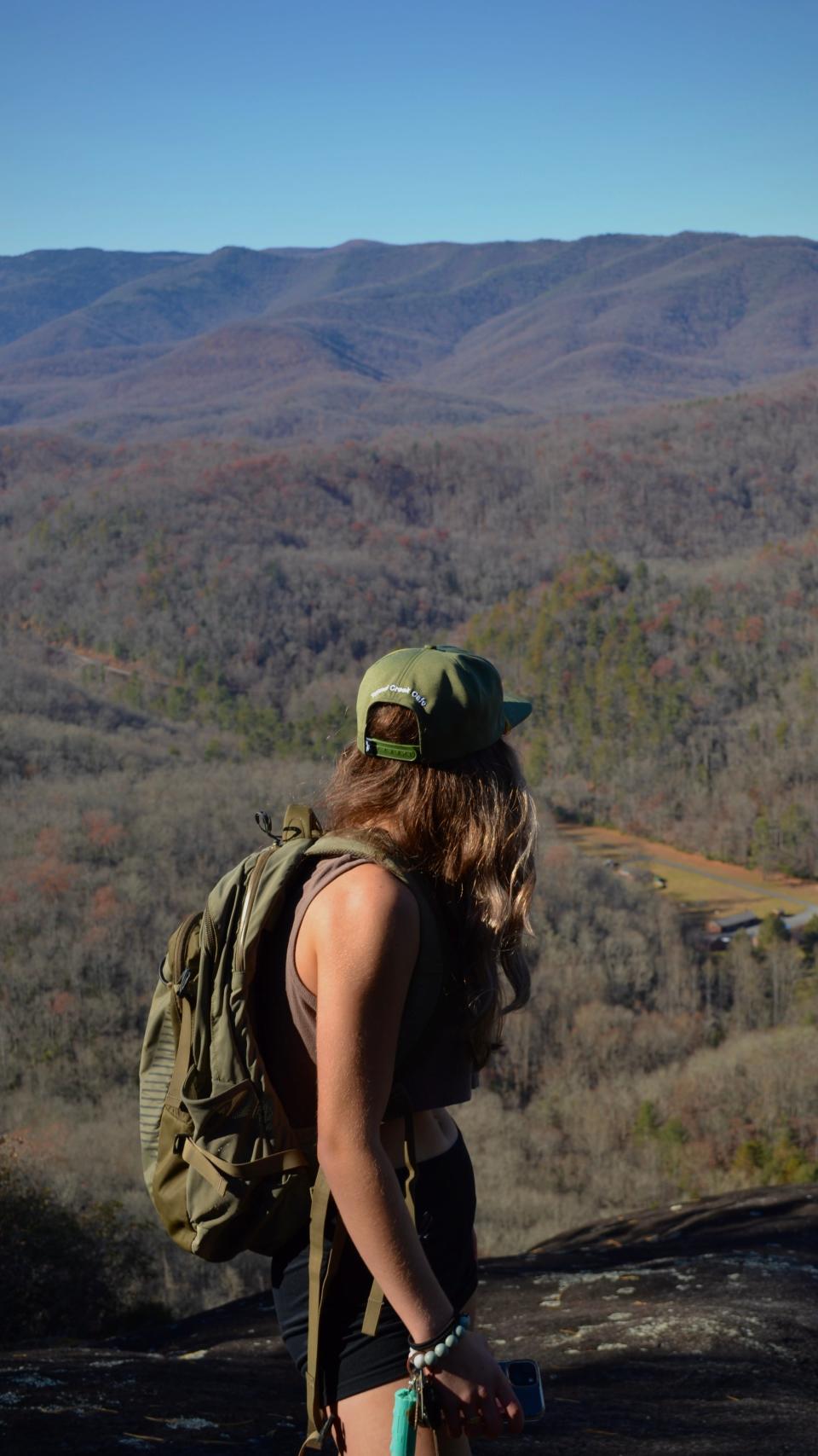Get Outside WNC founder Jenna Watson stands on John Rock in Pisgah National Forest. Get Outside WNC offers guided social hikes for all ages and abilities to encourage a love for the outdoors and teach the importance of conservation.