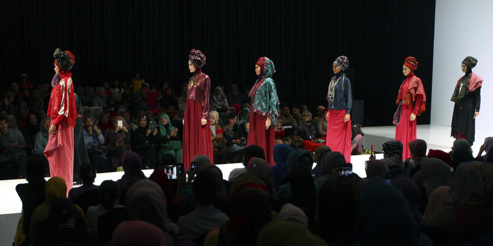 In this Saturday, May 31, 2013 photo, models showcase creations by Indonesian designer Najua Yanti during the Islamic Fashion Fair in Jakarta, Indonesia. The event is part of the Indonesian government's effort to turn the most populous Muslim country into the world's Islamic fashion capital by 2020. (AP Photo/Dita Alangkara)