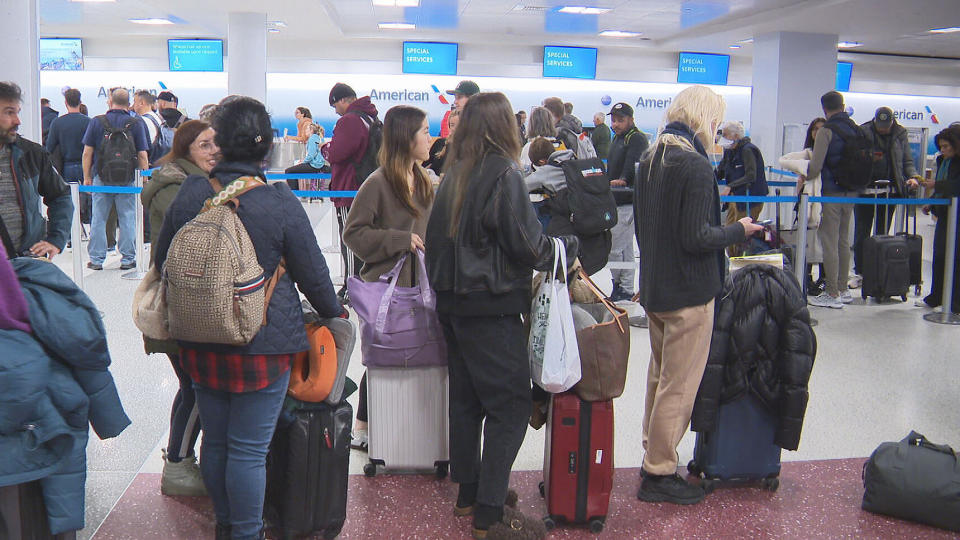 Passengers on American Airlines flight 94 wait for help at Logan Airport in Boston, February 28, 2024. / Credit: CBS Boston