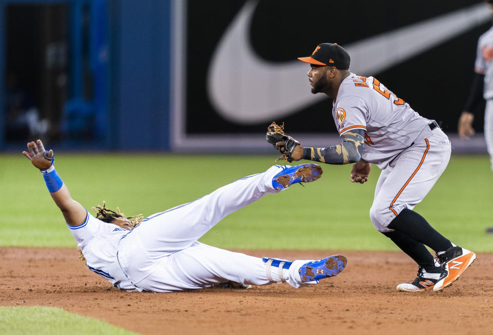 TORONTO, ONTARIO - SEPTEMBER 23: Hanser Alberto #57 of the Baltimore Orioles tags out Vladimir Guerrero Jr. #27 of the Toronto Blue Jays trying to stretch a double in the third inning during their MLB game at the Rogers Centre on September 23, 2019 in Toronto, Canada. (Photo by Mark Blinch/Getty Images)