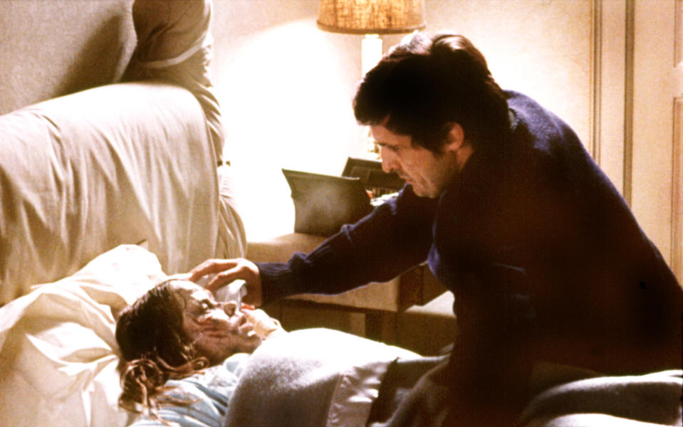 Jason Miller attends to a possessed Linda Blair in <em>The Exorcist.</em> (Photo: Warner Bros./Courtesy of the Everett Collection)