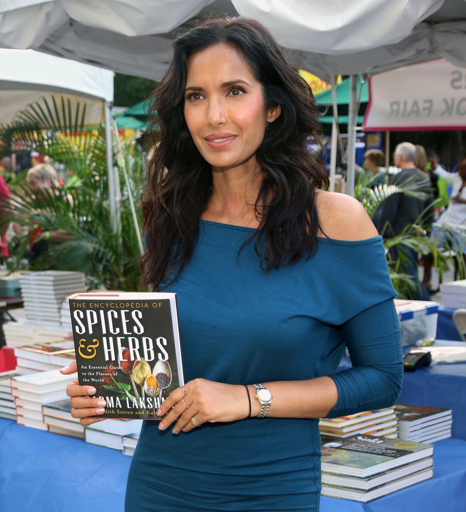 Padma Lakshmi holding up her book.