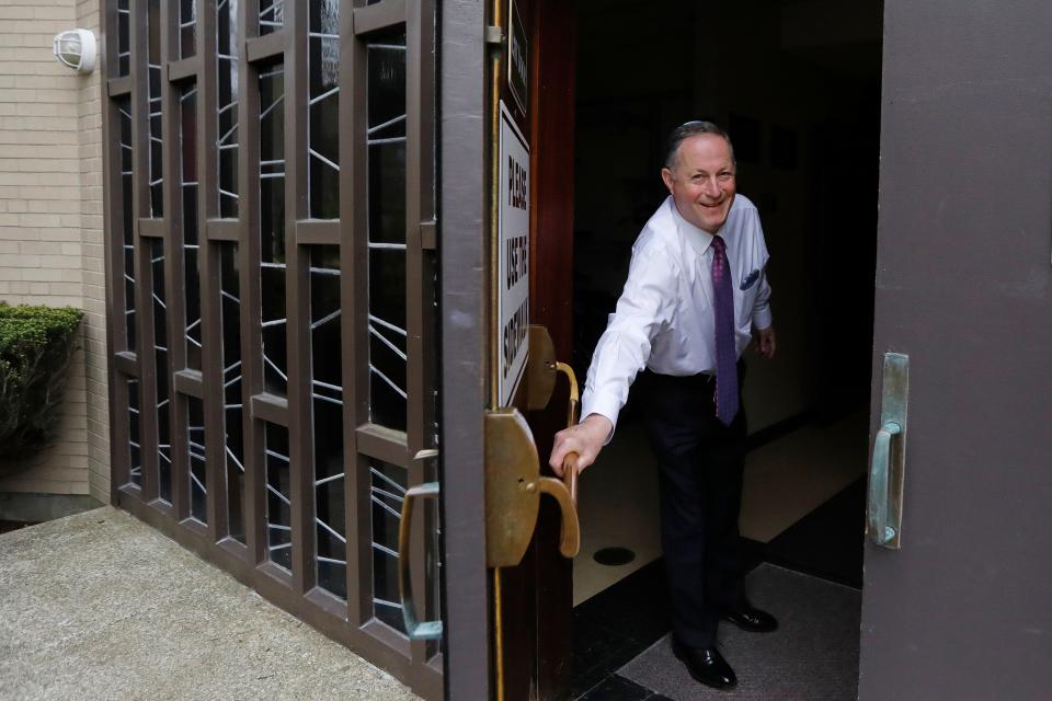 Rabbi Raphael Kanter opens the door to the Tifereth Israel Synagogue on Brownell Avenue in New Bedford, which is celebrating its 100th anniversary.