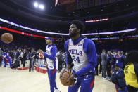 Philadelphia 76ers' Joel Embiid, front, and teammates wear jerseys with Kobe Bryant's number on them before the team's NBA basketball game against the Golden State Warriors on Tuesday, Jan. 28, 2020, in Philadelphia. Bryant died along with his daughter and seven other people during helicopter crash Sunday. (Steven M. Falk/The Philadelphia Inquirer via AP)