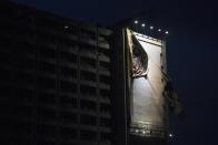 A torn advertisement banner hangs before Typhoon Usagi is expected to make landfall, outside a shopping mall at Tsim Sha Tsui shopping district in Hong Kong September 22, 2013. Hong Kong was bracing on Sunday for this year's most powerful typhoon, with government meteorologists warning of severe flooding created by a double whammy of powerful winds and exceptionally high tides. REUTERS/Tyrone Siu