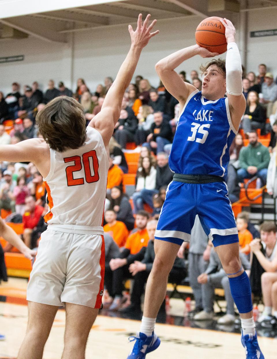 Lake's Landyn Roth shoots over the pressure of Green's Brady Rollyson in the first half at Green, Friday, January 27, 2023.