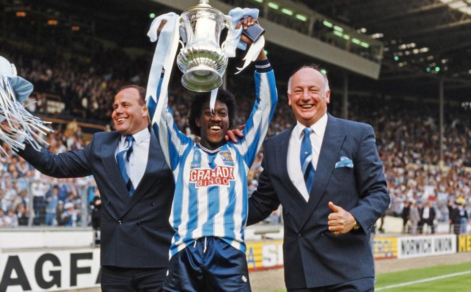 Coventry City goalscorer Dave Bennett (c) lifts the trophy flanked by managerial team George Curtis (l) and John Sillett after the 1987 FA Cup Final - Getty Images