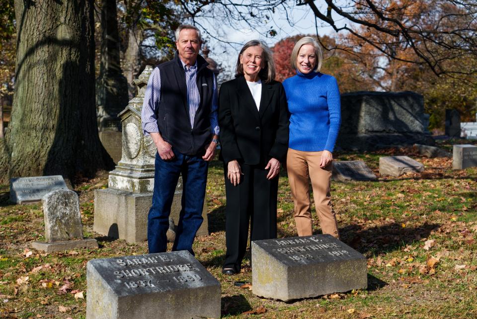 Tom Shortridge and his sister, Liz (right), stand with historian and researcher Sharon Butsch Freeland at the grave marker of Abraham Shortridge, a superintendent of Indianapolis Public Schools and second president of Purdue University, on Monday, Nov. 6, 2023, at Crown Hill Cemetery in Indianapolis. According to family members of Shortridge, his marker is misspelled, due likely to his second wife not knowing the family's history.