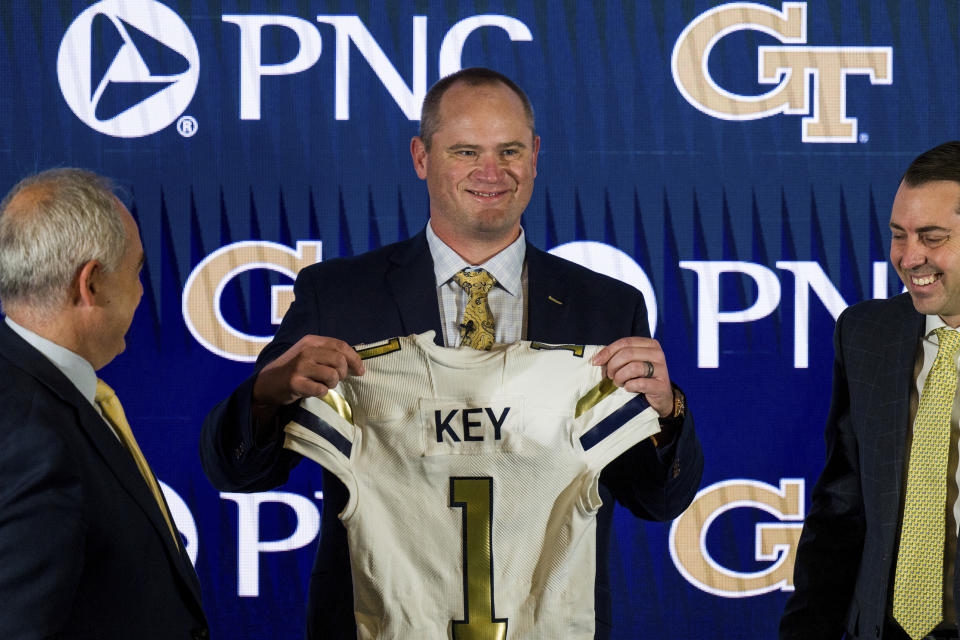 FILE - Newly hired Georgia Tech football coach Brent Key holds up a jersey during a news conference, Monday, Dec. 5, 2022, in Atlanta. Georgia Tech opens their season at home against Louisville on Sept. 1. Georgia Tech opens their season at home against Louisville on Sept. 1. (AP Photo/Danny Karnik, File)