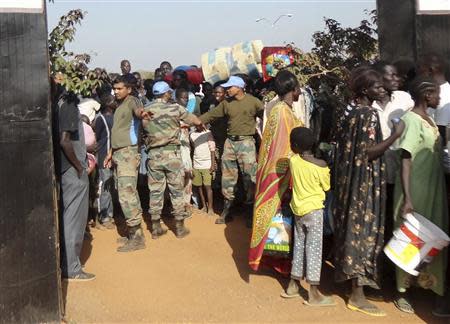 A contingent of peacekeepers from the United Nations Mission in the Republic of South Sudan (UNMISS) guide civilians arriving at the UN compound in the outskirts of South Sudan's capital Juba, in this December 16, 2013 handout provided by UNMISS. REUTERS/UNMISS/Handout via Reuters