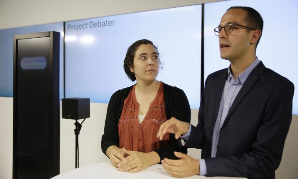 Noa Ovadia, left, and Dan Zafrir, right, prepare for their debate against the IBM Project Debater.