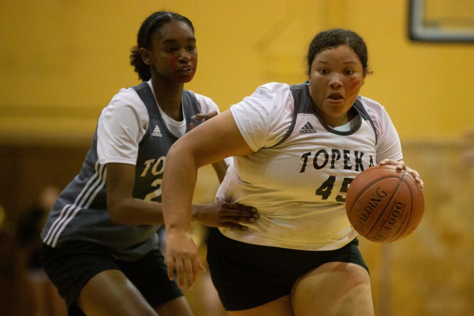 Jo'Mhara Benning (45) dribbles down court  during Tuesday's scrimmage at Late Night in the Dungeon. Benning is part Cherokee.