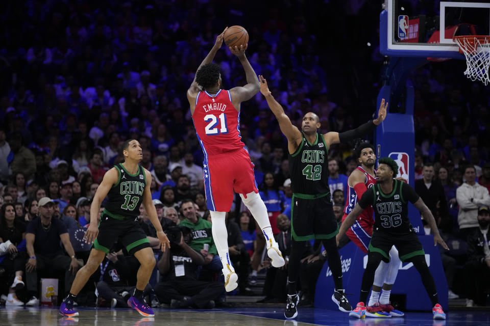 Philadelphia 76ers' Joel Embiid (21) goes up to shoot against Boston Celtics' Malcolm Brogdon (13), Al Horford (42) and Marcus Smart (36) during the second half of Game 3 in an NBA basketball Eastern Conference semifinals playoff series, Friday, May 5, 2023, in Philadelphia. (AP Photo/Matt Slocum)