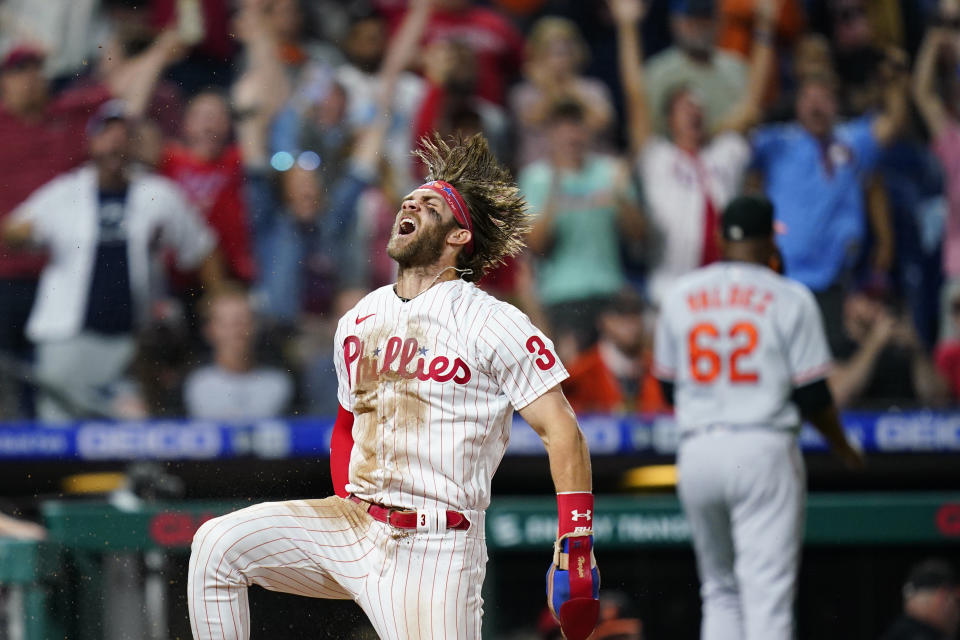 FILE - Philadelphia Phillies' Bryce Harper celebrates after scoring the game-winning run on a two-run triple by J.T. Realmuto during the 10th inning of an interleague baseball game against the Baltimore Orioles, Tuesday, Sept. 21, 2021, in Philadelphia. On Thursday, Nov. 18, 2021, Harper earned the National League MVP honor for the second time. (AP Photo/Matt Slocum, File)