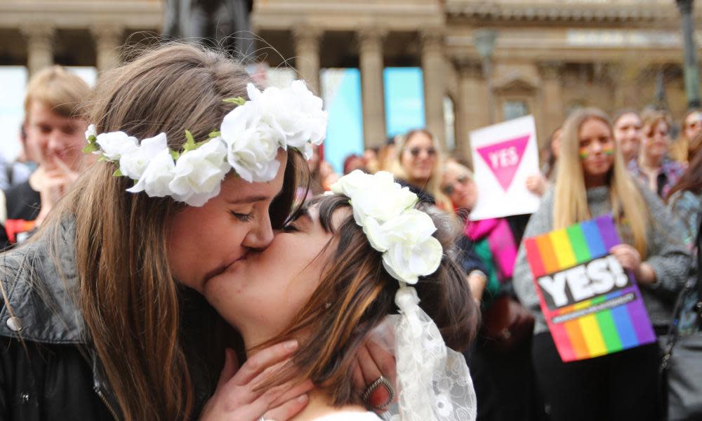 Two women kiss during a mock wedding during a rally for marriage equality in Melbourne.