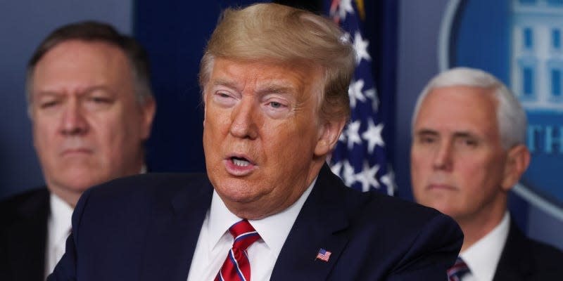 U.S. President Donald Trump addresses his administration's daily coronavirus task force briefing as Secretary of State Mike Pompeo and Vice President Mike Pence listen at the White House in Washington, U.S., March 20, 2020. REUTERS/Jonathan Ernst