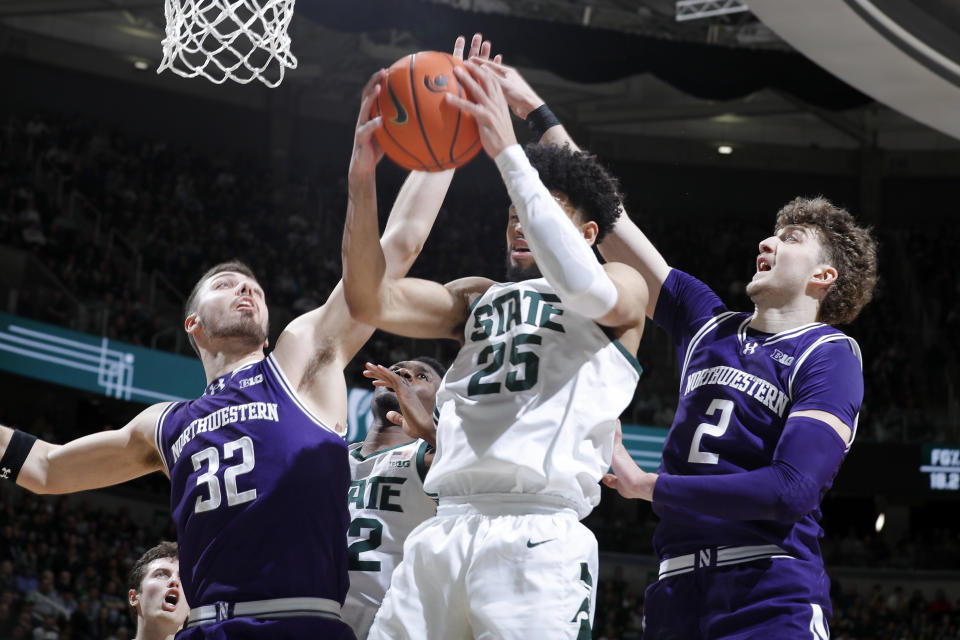 Michigan State forward Malik Hall (25), center, and Northwestern forwards Blake Preston (32), left, and Nick Martinelli (2) vie for a rebound during the first half of an NCAA college basketball game, Wednesday, March 6, 2024, in East Lansing, Mich. (AP Photo/Al Goldis)