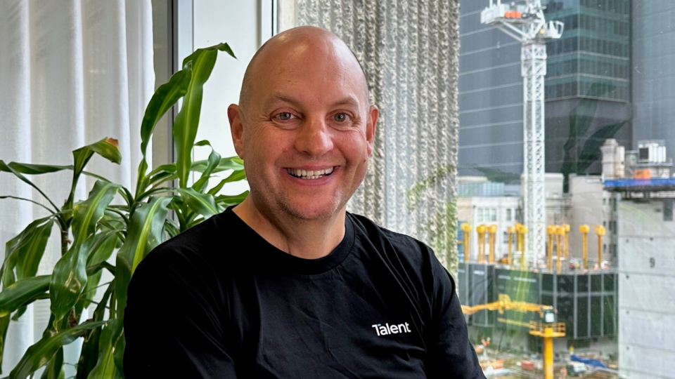 Career expert Mark Nielsen smiling into the camera he has a bald head and is wearing a black tshirt 