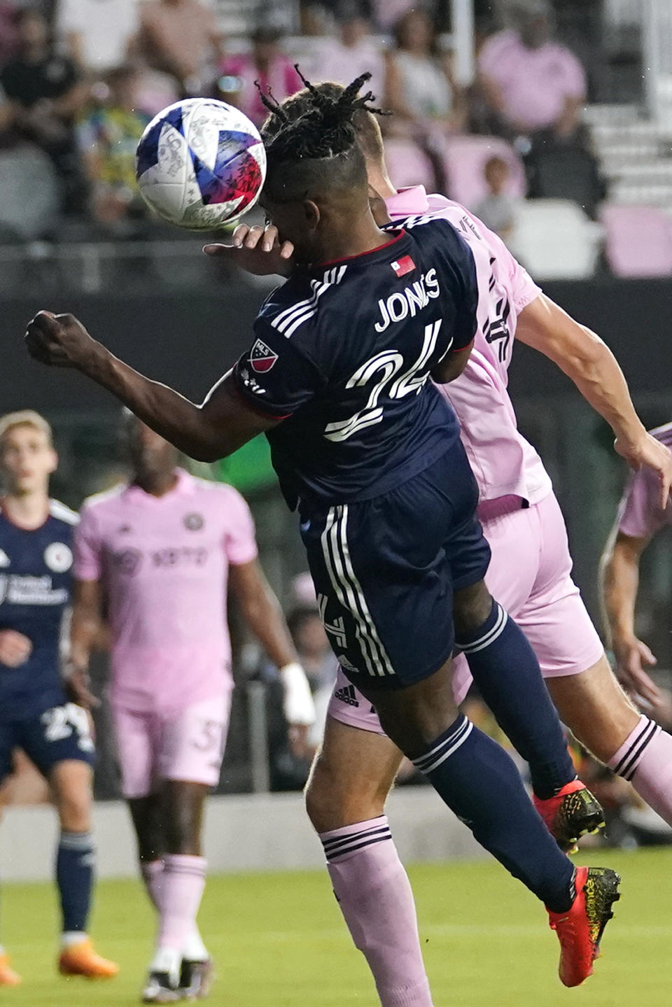 New England Revolution forward DeJuan Jones (24) heads the ball during the first half of the team's MLS soccer match against Inter Miami, Saturday, May 13, 2023, in Fort Lauderdale, Fla. (AP Photo/Lynne Sladky)