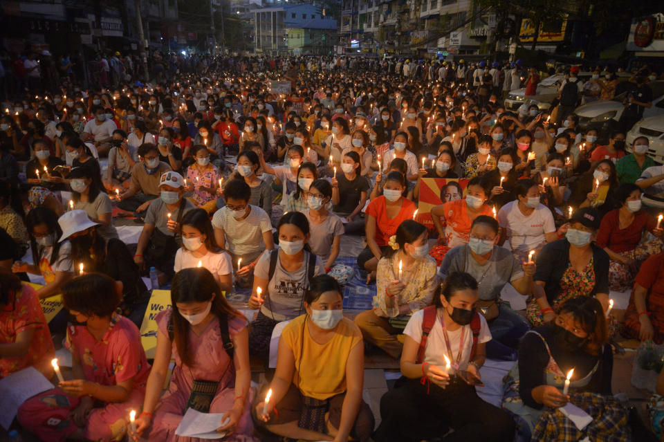 Protesters attend a candlelight night rally in Yangon, Myanmar, Saturday, Mar. 13, 2021. Security forces in Myanmar on Saturday again met protests against last month's military takeover with lethal force, killing at least four people by shooting live ammunition at demonstrators. (AP Photo)