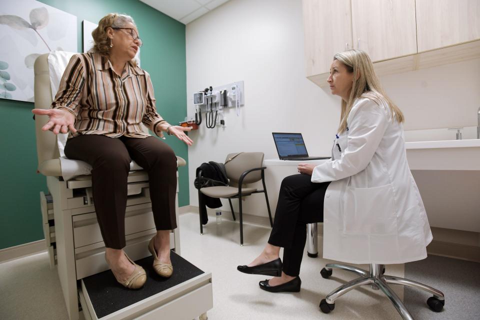 Patient Nydia Silva talks with advanced practice nurse Lyndsay Holmes at the new Florida Blue Sanitas Medical Center Friday. The new facility in Jacksonville's Regency area is exclusively for patients 50 and older who are insured through Florida Blue.