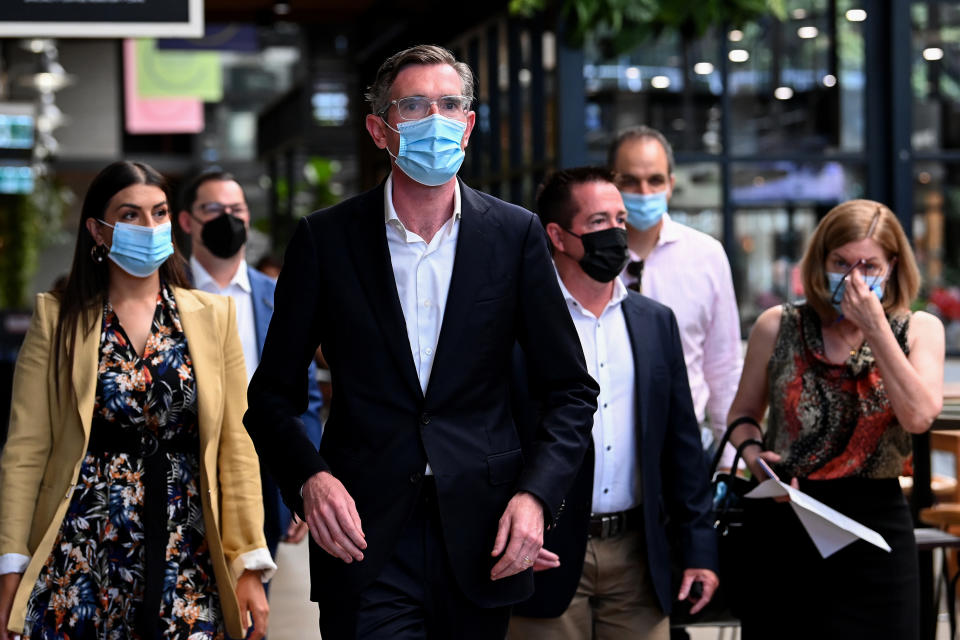 NSW Premier Dominic Perrottet (centre) arrives for a Covid press conference at The Cannery in Sydney, Sunday, January 30, 2022. Source: AAP