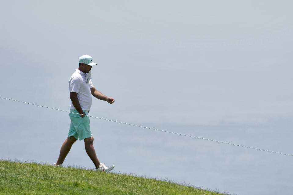 Brooks Koepka walks to the fourth tee during a practice round of the U.S. Open Golf Championship, Tuesday, June 15, 2021, at Torrey Pines Golf Course in San Diego. (AP Photo/Jae C. Hong)