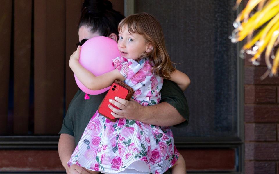  Cleo Smith, right, and her mother Ellie Smith leave a house where they spent the night after 4-year-old Cleo was rescued in Carnarvon, Australia, Thursday, Nov. 4, 2021. Police expected to charge a local man with abducting Cleo from her family's camping tent 18 days before police smashed into a locked house and rescued her in an outcome celebrated around Australia. (Richard Wainwright/AAP Image via AP) - AP