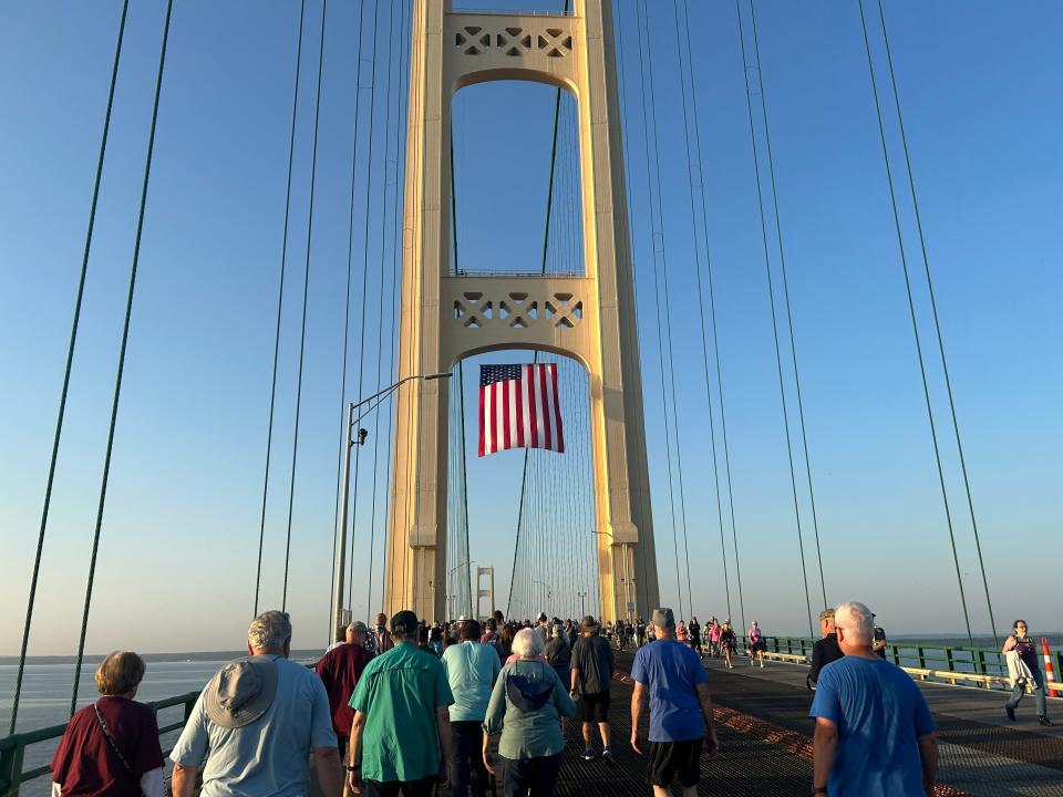 An American flag hangs from the northern post of the Mackinac Bridge as pedestrians passed underneath during the Mackinac Bridge Walk on Labor Day.