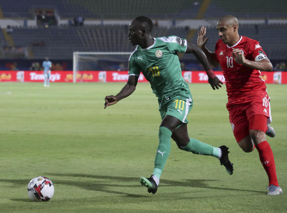 Senegal's Sadio Mane in action in front of TTunisia's Wahbi Khazri during the African Cup of Nations semifinal soccer match between Senegal and Tunisia in 30 June stadium in Cairo, Egypt, Sunday, July 14, 2019. (AP Photo/Hassan Ammar)