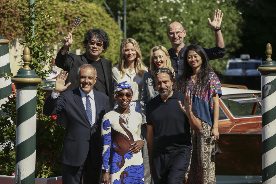 FILE - In this Sept, 1, 2021 file photo Jury President Bong Joon Ho, from top left, Jury members Virginie Efira, Sarah Gadon, Alexander Nanau, director of the Venice Film festival Alberto Barbera, from bottom left, jury members Cynthia Erivo, Saverio Costanzo and Chloe Zhao pose for photographers upon arrival at the 78th edition of the Venice Film Festival in Venice, Italy. (Photo by Joel C Ryan/Invision/AP, File)