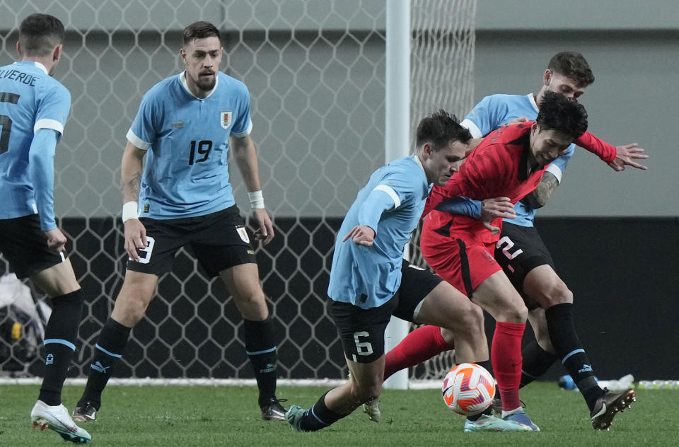 South Korea's Son Heung-min, second right, fights for the ball against Uruguay's Manuel Ugarte Ribeiro, third right, during an international friendly soccer match between South Korea and Uruguay in Seoul, Sough Korea, Tuesday, March 28, 2023. (AP Photo/Ahn Young-joon)