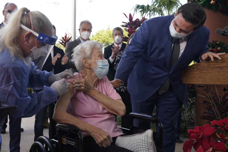 Florida Gov. Ron DeSantis asks Vera Leip, 88, how she feels after nurse Christine Philips, left, administered the Pfizer vaccine at John Knox Village, Wednesday, Dec. 16, 2020, in Pompano Beach, Fla. Nursing home residents and health care workers in Florida began receiving the Pfizer vaccine this week. (AP Photo/Marta Lavandier)