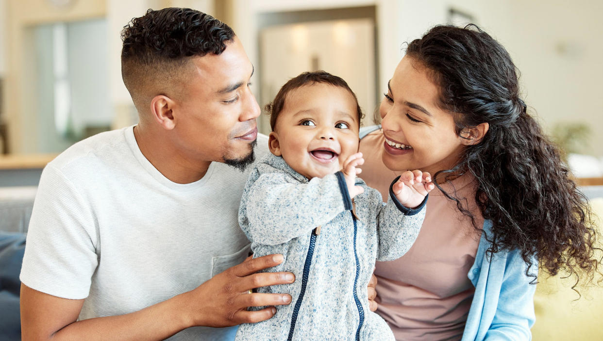 Shot of a young family bonding with their baby at home (Getty Images)