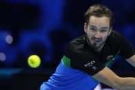 Russia's Daniil Medvedev returns the ball to Spain's Carlos Alcaraz during their singles tennis match of the ATP World Tour Finals at the Pala Alpitour, in Turin, Italy, Friday, Nov. 17, 2023. (AP Photo/Antonio Calanni)