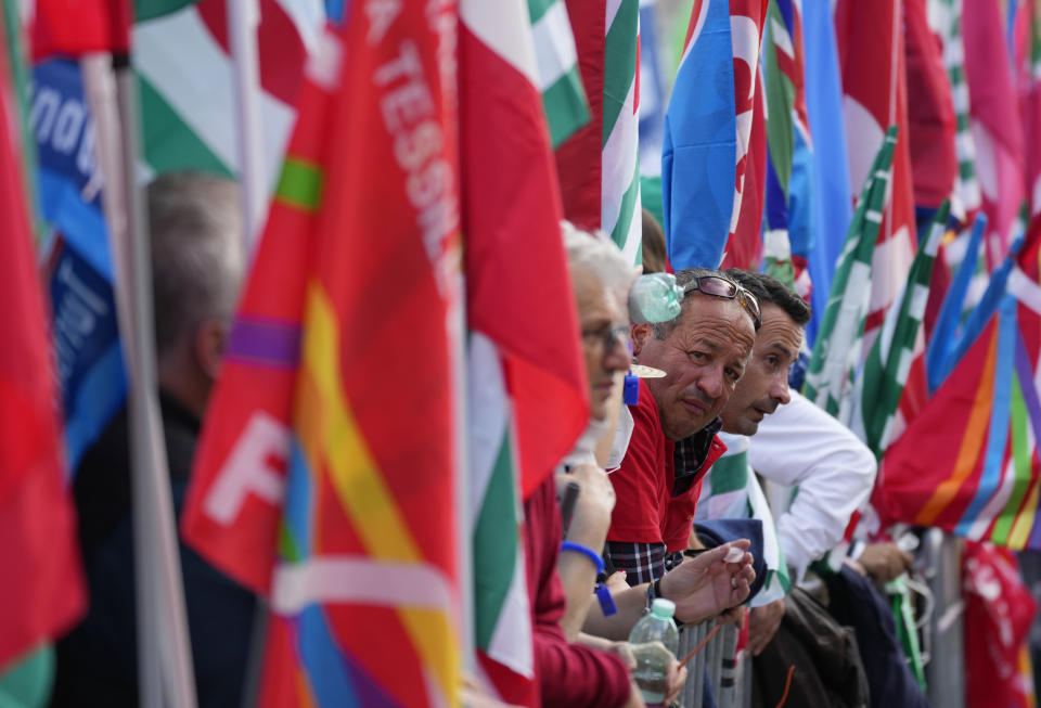 Demonstrators take part in a march organized by Italy's main labor unions, in Rome's St. John Lateran square, Saturday, Oct. 16, 2021. The march was called a week after protesters, armed with sticks and metal bars, smashed their way into the headquarters of CGIL, a left-leaning union, and trashed its office, during a demonstration to protest a government rule requiring COVID-19 vaccines or negative tests for workers to enter their offices. (AP Photo/Andrew Medichini)