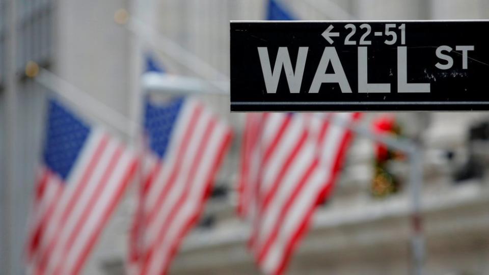 A street sign for Wall Street is seen outside the New York Stock Exchange (NYSE) in Manhattan, New York City, U.S. December 28, 2016