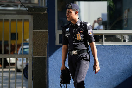 A police officer stands outside the morgue at Kuala Lumpur General Hospital where Kim Jong Nam's body is held for autopsy in Malaysia February 18, 2017. REUTERS/Athit Perawongmetha