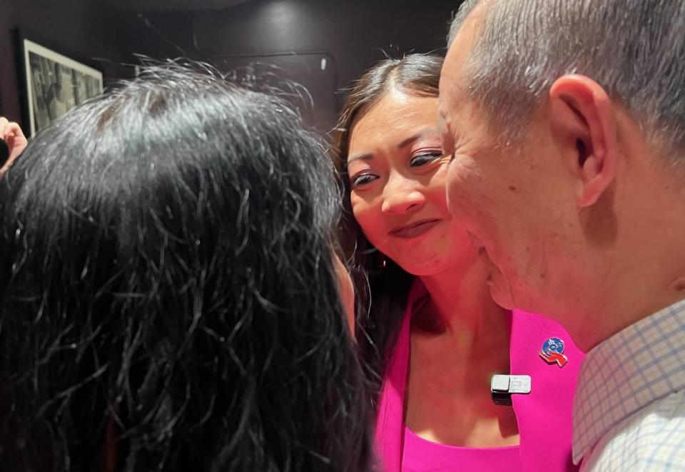 Lily Wu celebrates her election victory over Mayor Brandon Whipple with her parents at her watch party Tuesday night.