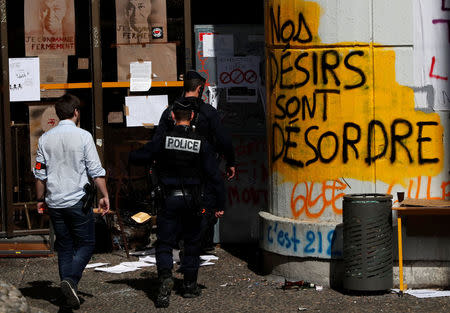 French police enter the Tolbiac university site, branch of Paris 1 university, after the evacuation of around 100 people who had occupied the university premises in protest against student admissions rules, in Paris, France, April 20, 2018. REUTERS/Gonzalo Fuentes