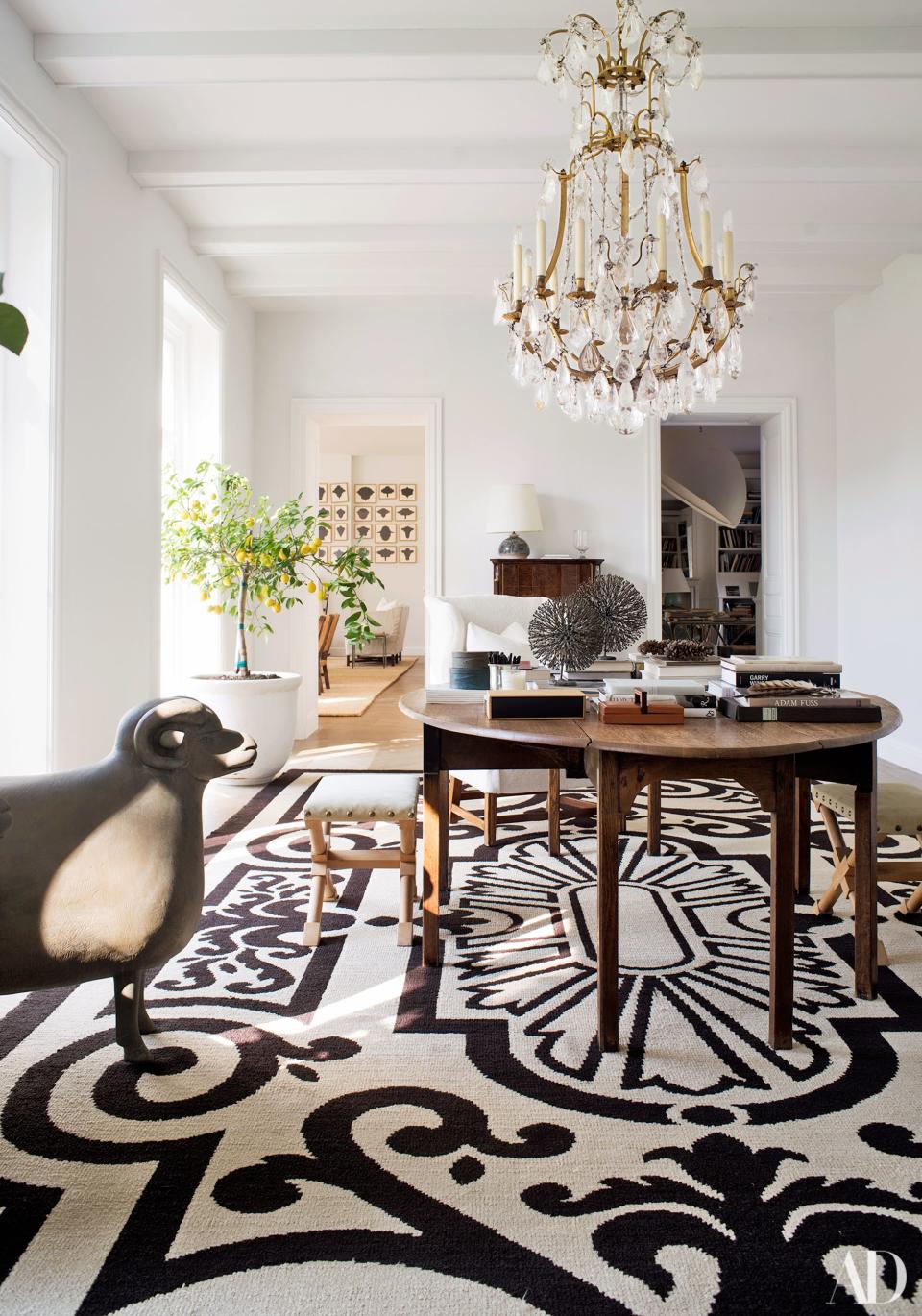 A François-Xavier Lalanne bronze sheep keeps watch in the main gallery. Louis XVI rock-crystal chandelier; George III table; André Arbus stools; vintage Cogolin rug by Henri Gonse.